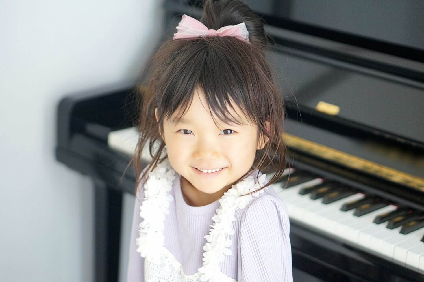 ピアノのそばで笑顔の子ども
